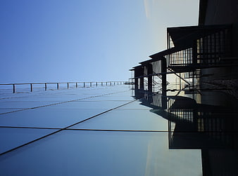 Modern architectural steel staircase on reflective glass roof