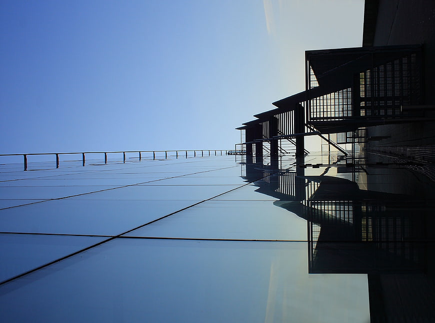Modern architectural steel staircase on reflective glass roof