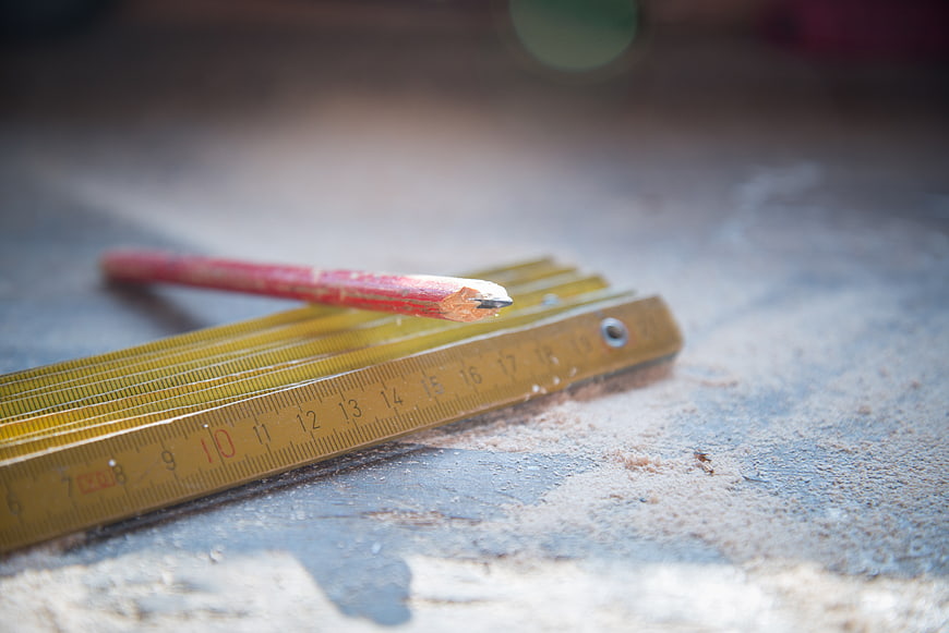 Close-up of carpenter ruler and pencil on workbench