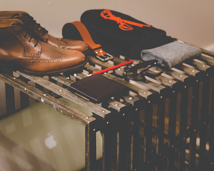 Men's fashion accessories and leather shoes on wooden crate