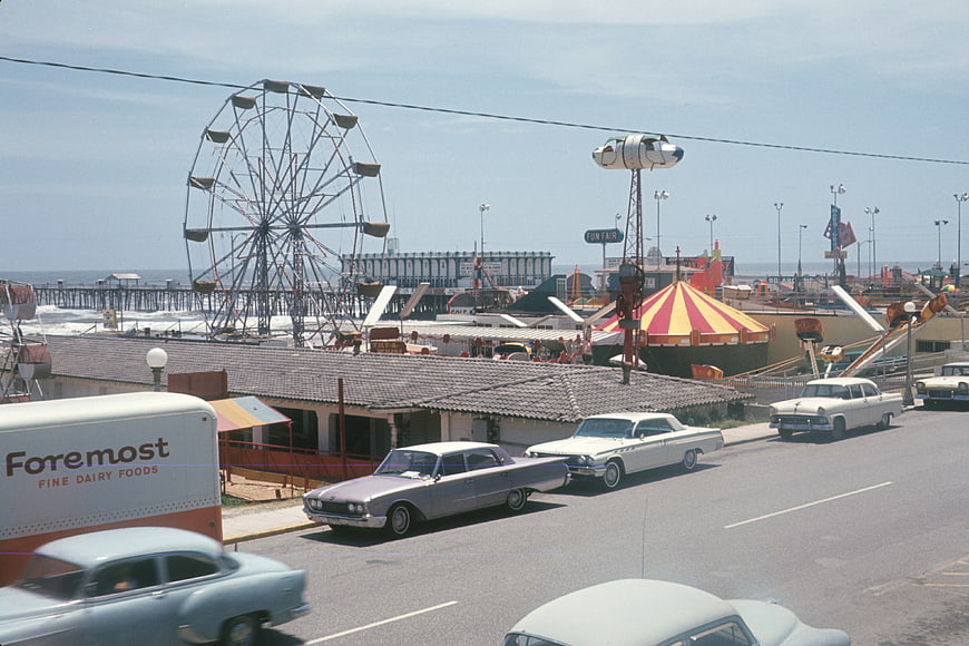 Vintage 1950s Beach Boardwalk with Classic Cars and Ferris Wheel