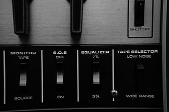 Close-up of vintage audio equipment switches and equalizer panel
