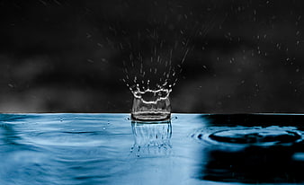 Blue Water Splash Droplet Impact on Dark Background
