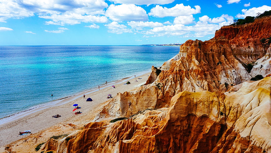 Aerial View of Orange Cliffs and Turquoise Beach