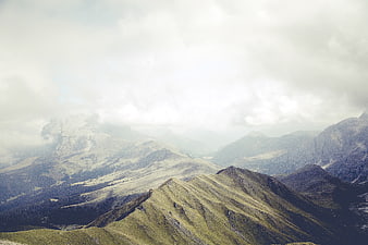 Misty Mountain Landscape with Clouds and Green Peaks