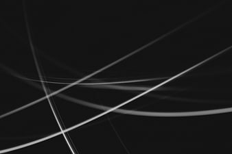 Abstract white light streaks on black background
