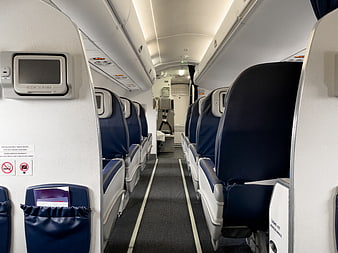 Empty Economy Class Airplane Cabin Interior with Blue Seats