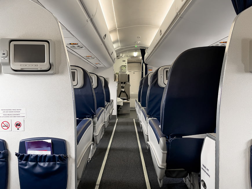 Empty Economy Class Airplane Cabin Interior with Blue Seats