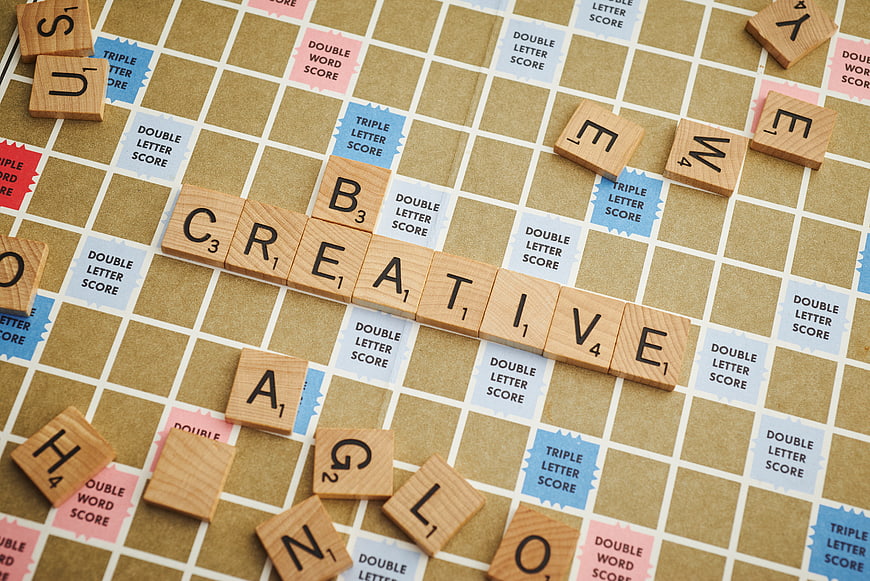 Creative spelled with wooden Scrabble tiles on game board