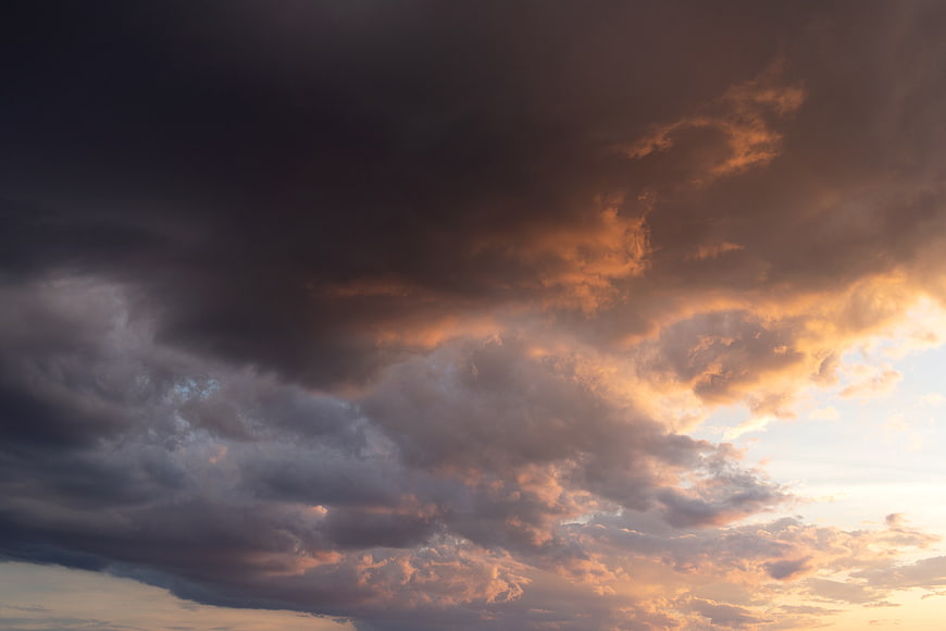 Dramatic sunset sky with dark storm clouds and golden light