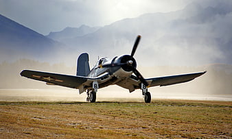 Vintage Corsair Fighter Plane Taking Off on Grassy Runway