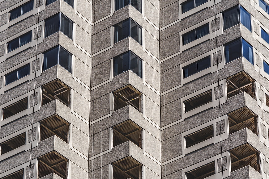 Modern Concrete Apartment Building Facade with Geometric Windows