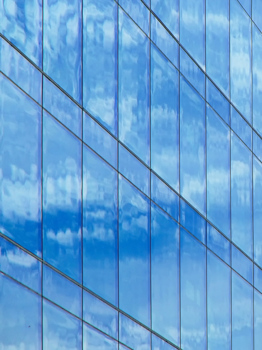 Blue Glass Building Facade with Cloud Reflections