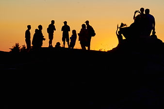 Silhouette of Hikers Watching Sunset on Mountain Ridge
