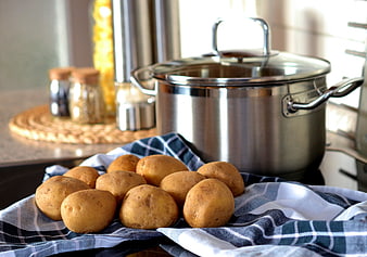 Raw Potatoes on Kitchen Towel Near Stainless Steel Pot