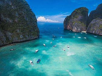 Aerial view of turquoise bay with boats and limestone cliffs