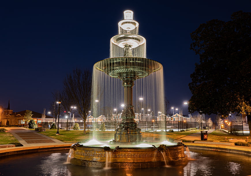 Illuminated Tiered Fountain at Night in Urban Park