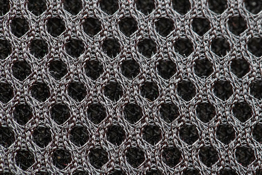Close-up of textured gray and black woven mesh fabric pattern