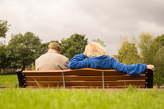 Senior Couple Sitting on Park Bench from Behind