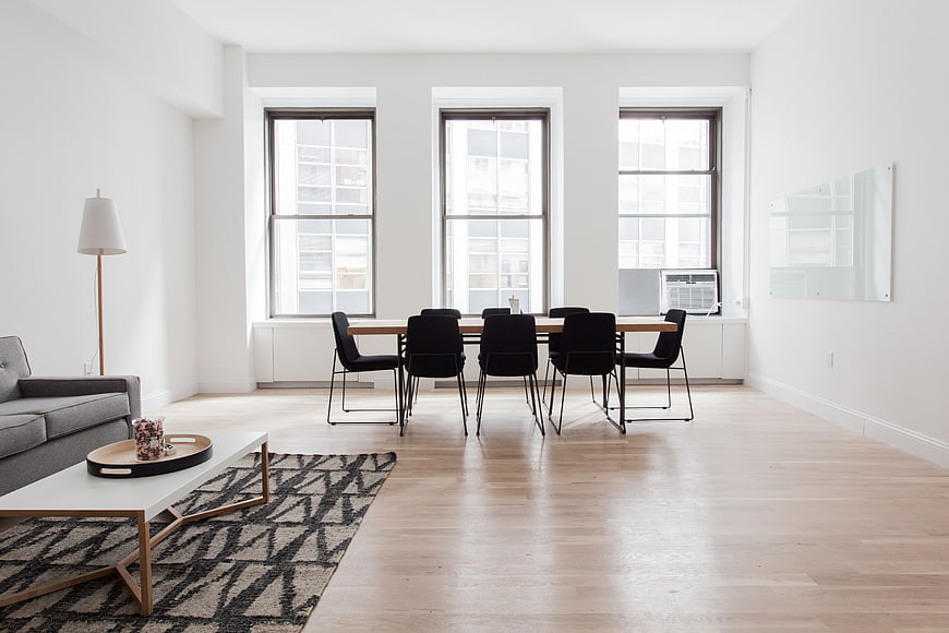 Modern minimalist apartment interior with dining table and living area