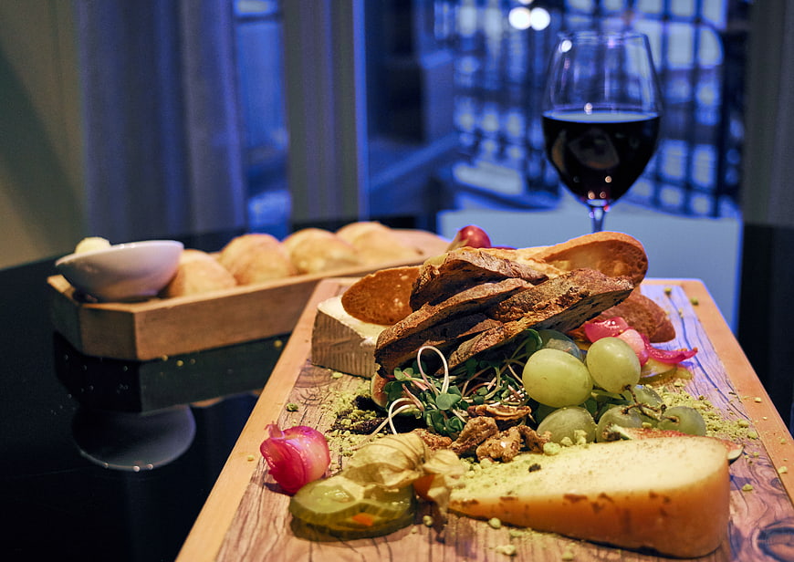 Gourmet cheese board with wine and bread