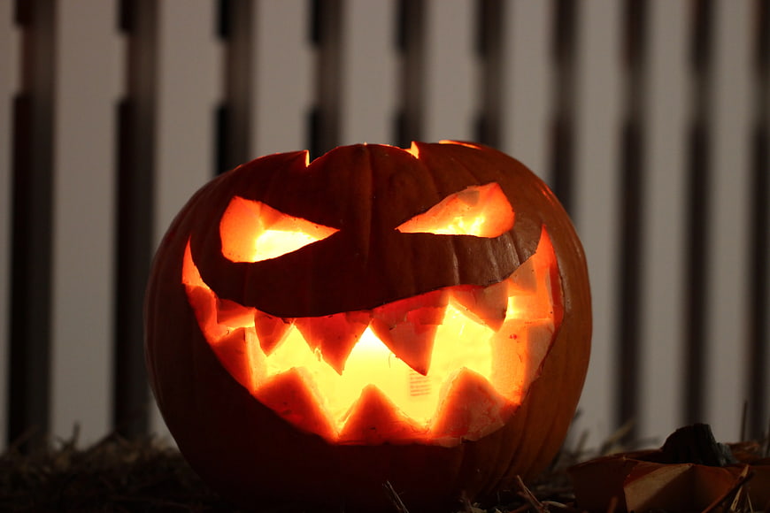 Glowing Jack-o'-lantern with carved face at night