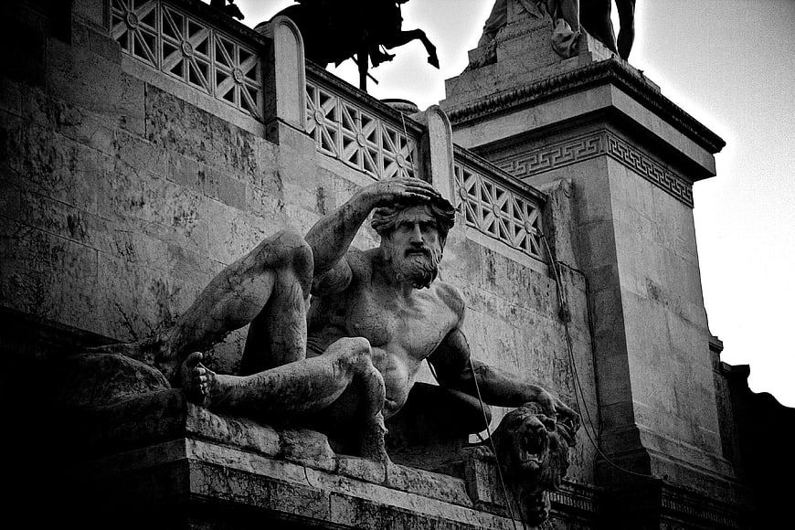 Dramatic Black and White Photo of Ancient Roman Stone Sculpture