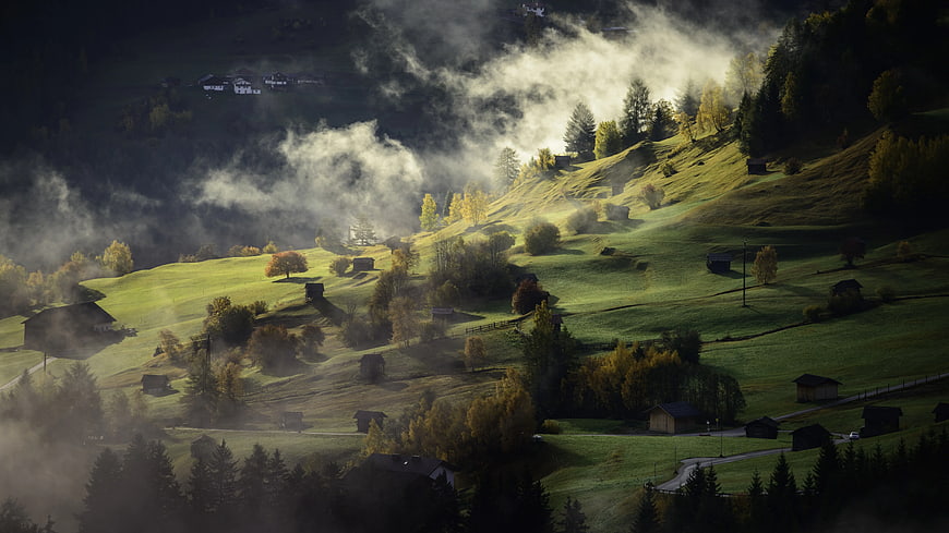 Misty Green Mountain Hills with Autumn Trees and Farmhouses