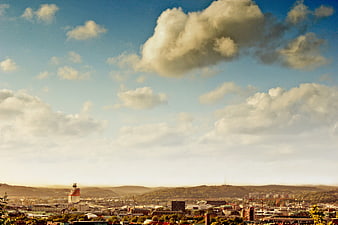 Panoramic Cityscape with Dramatic Clouds and Blue Sky