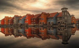 Colorful waterfront houses with reflection in calm water