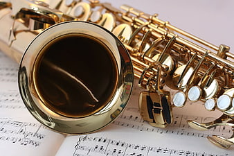 Close-up of Gold Saxophone on Sheet Music