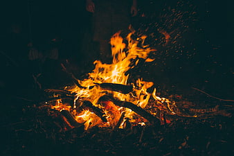 Campfire at Night with Sparks Flying into the Dark