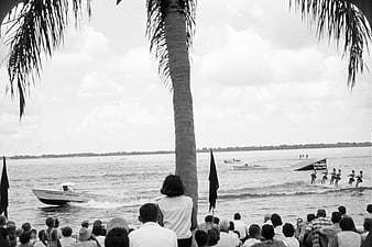 Vintage black and white photo of water ski show with audience