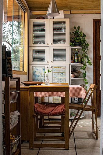 Rustic kitchen interior with wooden furniture and checkered tablecloth
