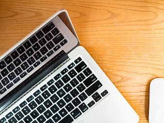 Top View of MacBook Keyboard on Wooden Desk