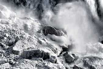 Dramatic black and white frozen waterfall with ice formations