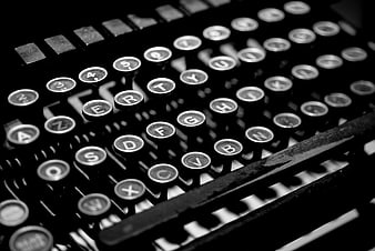 Close-up of vintage typewriter keys in black and white