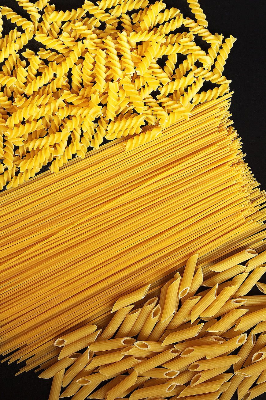 Top View of Uncooked Fusilli, Spaghetti, and Penne Pasta