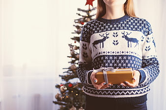 Woman in Reindeer Sweater Holding Christmas Gift