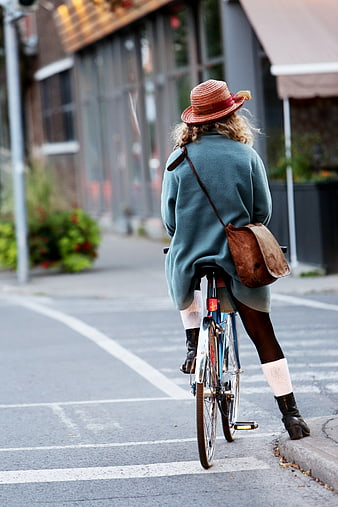 Woman on Bicycle in City Street