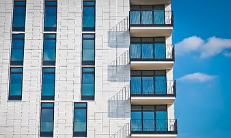 Modern White Apartment Building with Blue Sky
