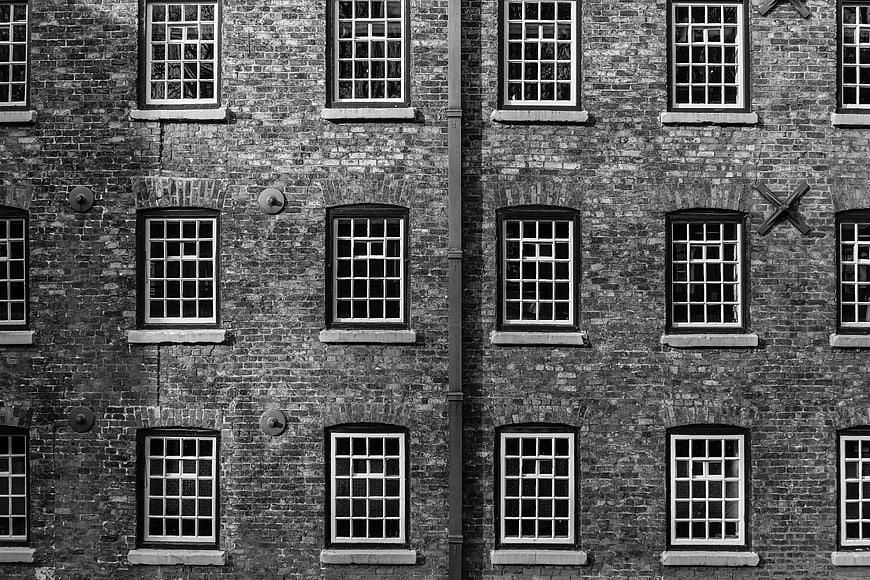 Black and white brick building facade with symmetrical windows
