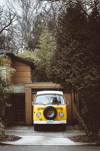 Vintage Yellow Volkswagen Bus Parked in Driveway