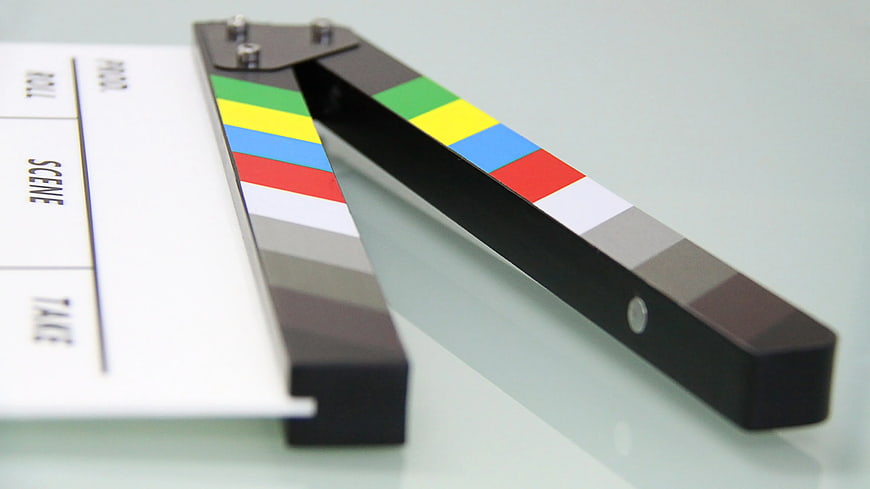 Close-up of a film clapperboard with color calibration bars