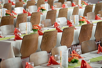 Formal Banquet Hall With Set Tables and Orange Napkins