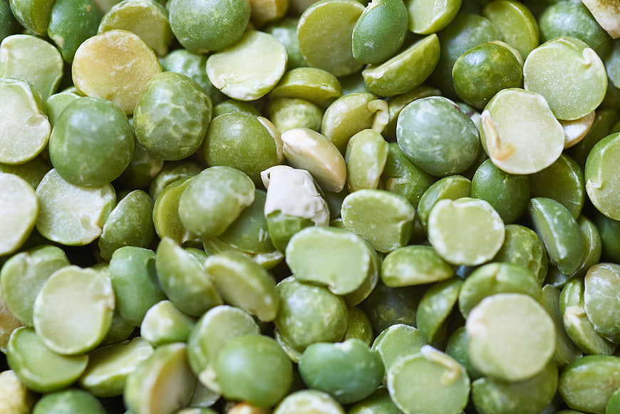 Close-up of raw green split peas texture background