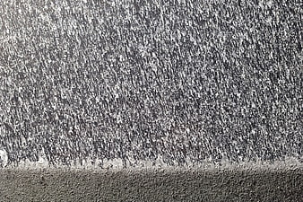Abstract texture of salt crystals on a dark car hood