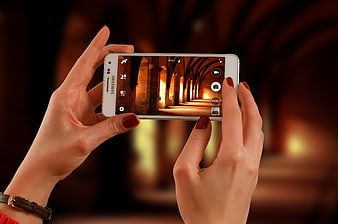 Woman taking photo of architecture with smartphone