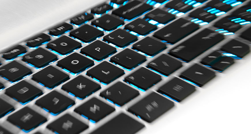 Close-up of laptop keyboard with blue backlighting