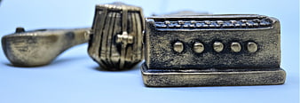 Close-up of vintage metal toy typewriter on blue background